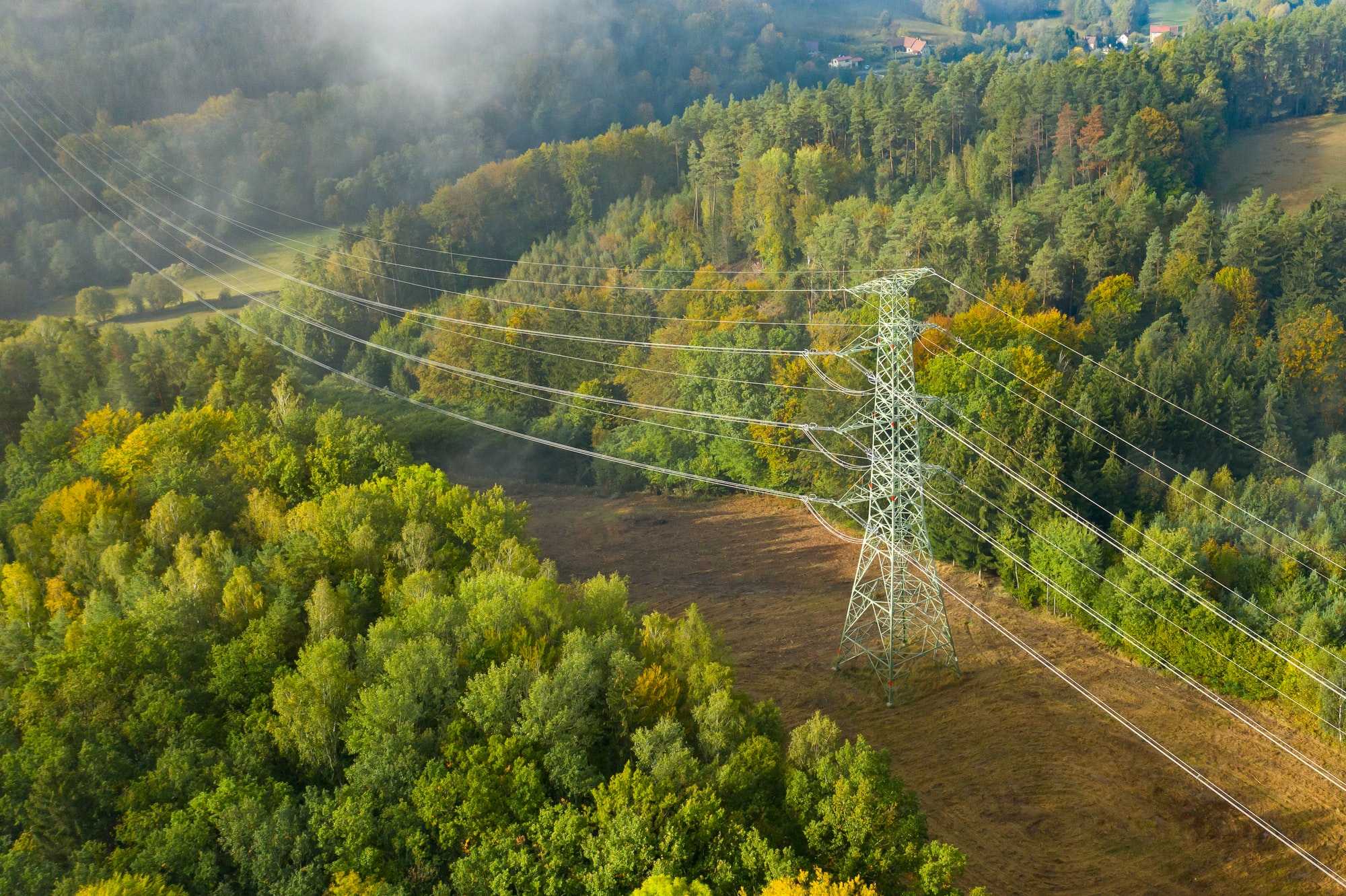 Aerial view of the high voltage power lines and high voltage electric transmission on the terrain