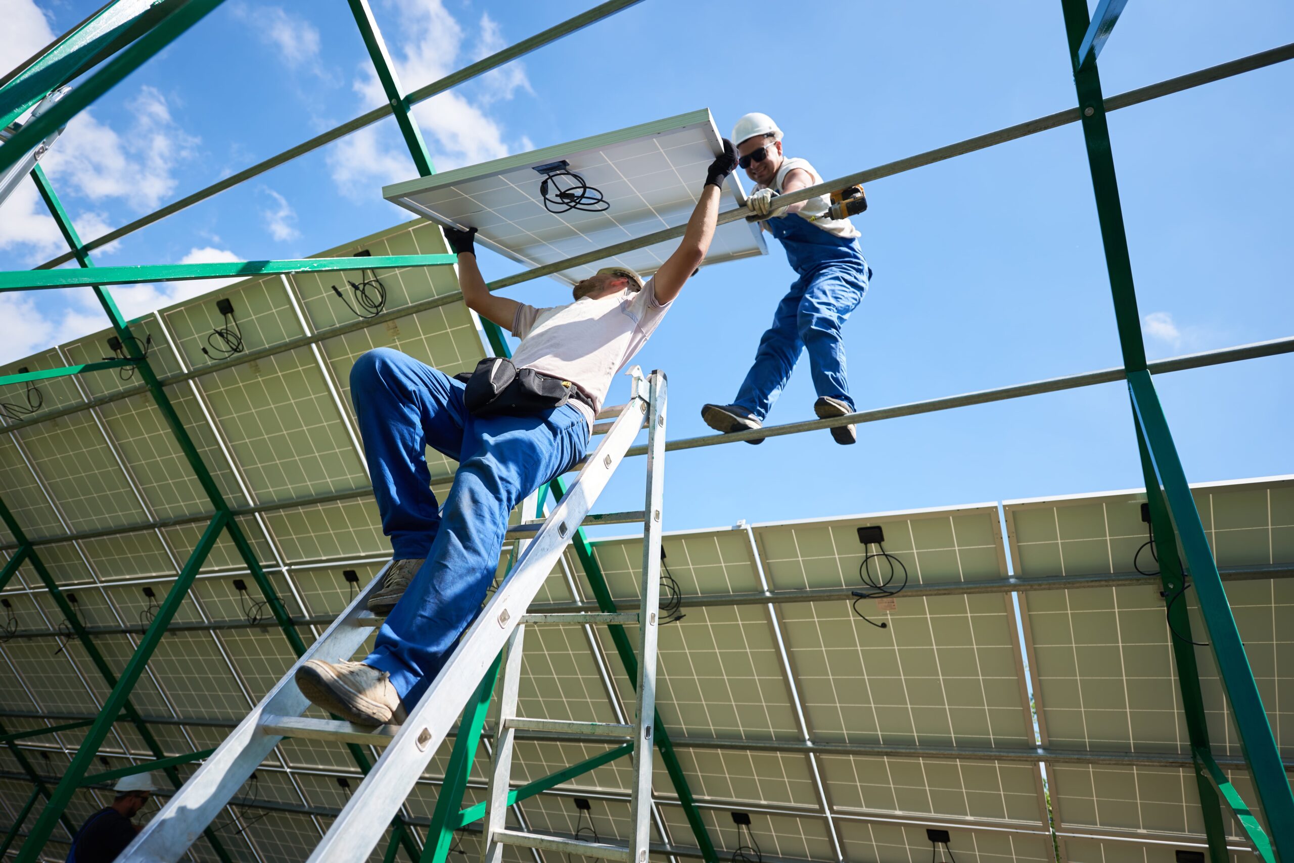 two-workers-mounting-solar-batteries-on-metallic-Solar-Panel-Manufacturing-in-America